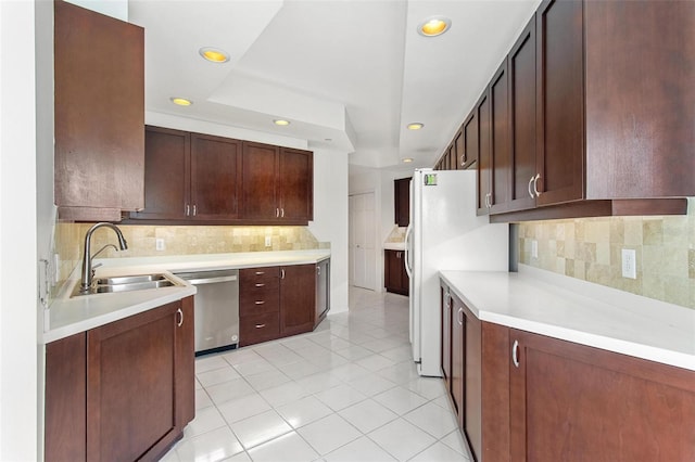 kitchen with dishwasher, sink, tasteful backsplash, white refrigerator, and light tile patterned floors