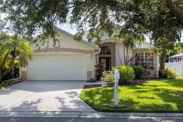 ranch-style home with a garage and a front yard