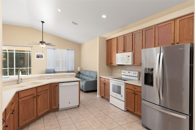 kitchen featuring white appliances, sink, light tile patterned floors, lofted ceiling, and ceiling fan