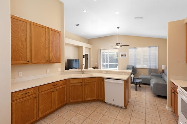 kitchen featuring sink, lofted ceiling, kitchen peninsula, and white appliances