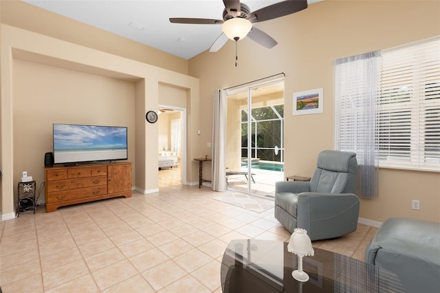 tiled living room featuring ceiling fan