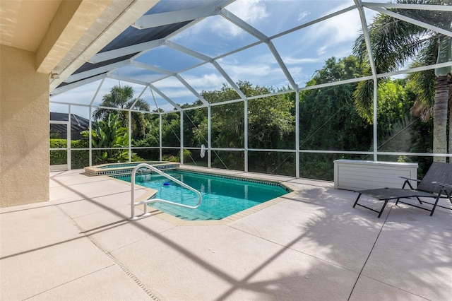 view of pool featuring a patio and glass enclosure