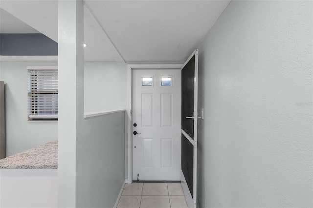 entryway with light tile patterned floors