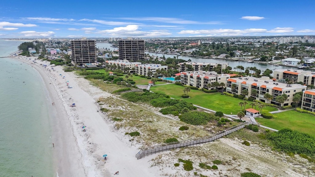 birds eye view of property with a water view and a view of the beach