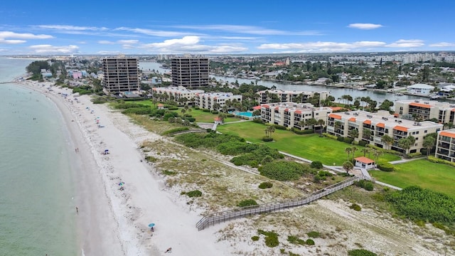 birds eye view of property with a water view and a view of the beach