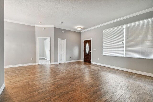 unfurnished living room featuring ornamental molding, a textured ceiling, and hardwood / wood-style floors