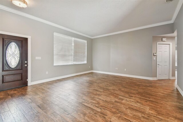 entrance foyer with wood-type flooring and crown molding