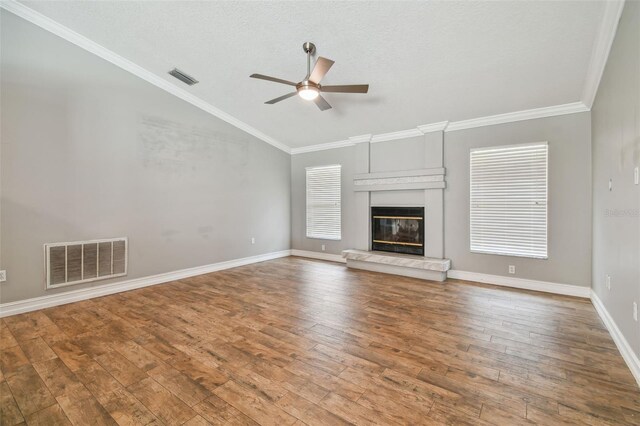 unfurnished living room featuring wood-type flooring, crown molding, vaulted ceiling, and ceiling fan