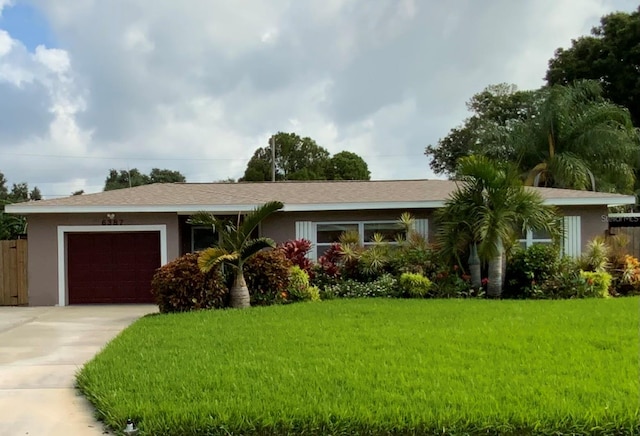 ranch-style house with a garage and a front lawn