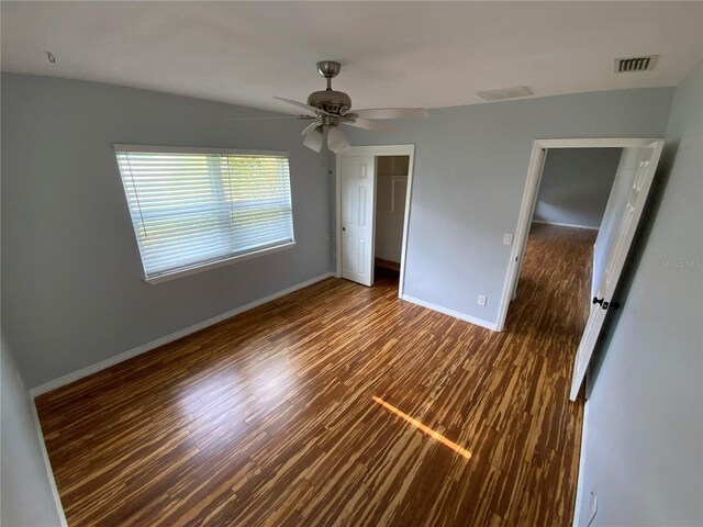 spare room featuring ceiling fan and dark hardwood / wood-style flooring