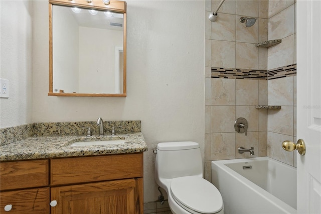 full bathroom featuring toilet, tiled shower / bath, and vanity