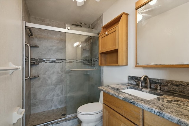 bathroom featuring toilet, walk in shower, and vanity