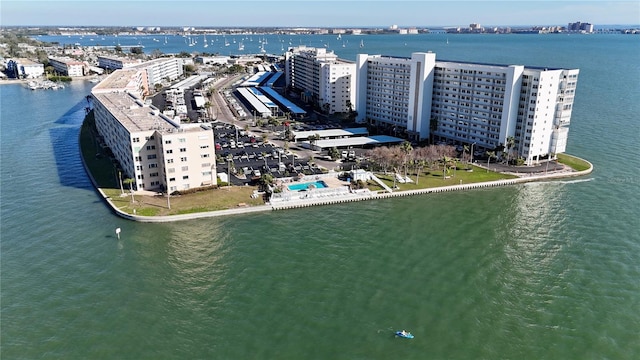 birds eye view of property with a water view and a city view