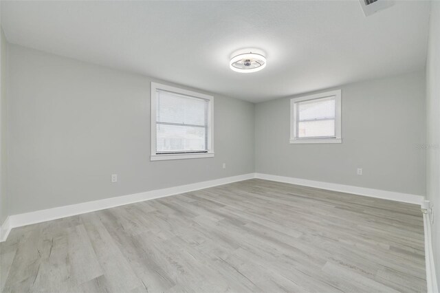 unfurnished room with light hardwood / wood-style flooring