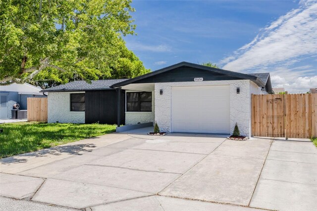 ranch-style house with a garage and central AC