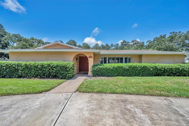 ranch-style house with a front lawn