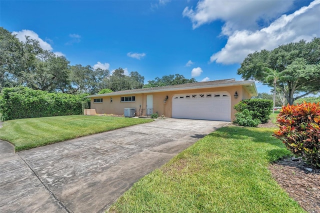 single story home featuring a garage, cooling unit, and a front yard