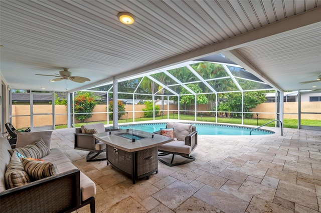 view of swimming pool featuring outdoor lounge area, ceiling fan, a patio area, and a lanai