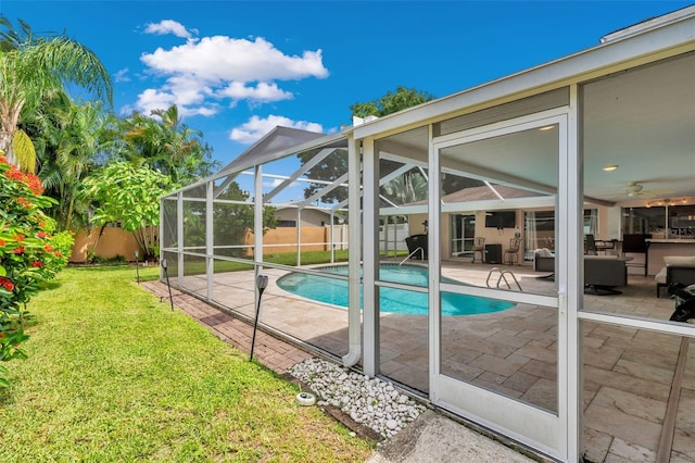 view of swimming pool featuring a patio, an outdoor hangout area, a lanai, and a yard