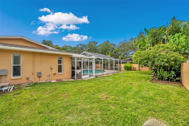 view of yard featuring glass enclosure