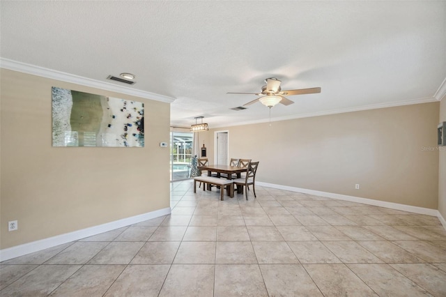 unfurnished dining area featuring a textured ceiling, ornamental molding, light tile patterned floors, and ceiling fan