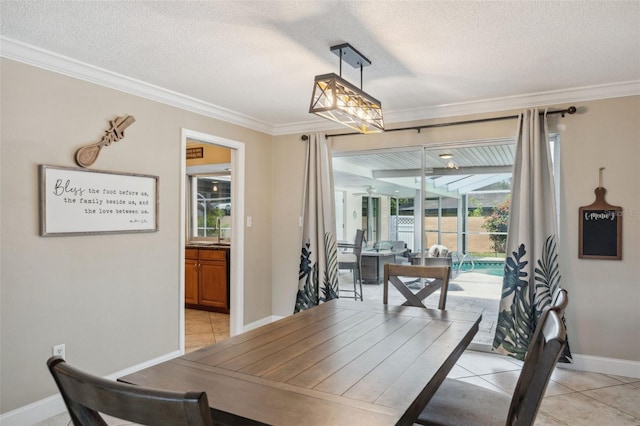 dining room featuring light tile patterned flooring, crown molding, and a textured ceiling