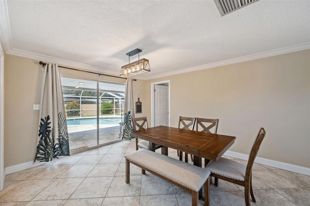 dining area with ornamental molding and light tile patterned floors