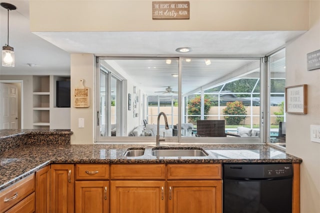 kitchen with sink, dishwasher, dark stone counters, and decorative light fixtures