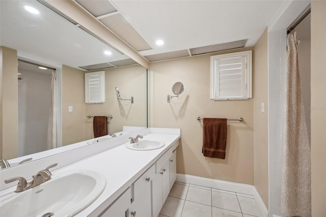 bathroom with double vanity and tile patterned flooring