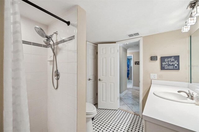 bathroom with vanity, tile patterned floors, and toilet