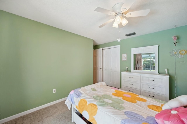 carpeted bedroom with a closet and ceiling fan