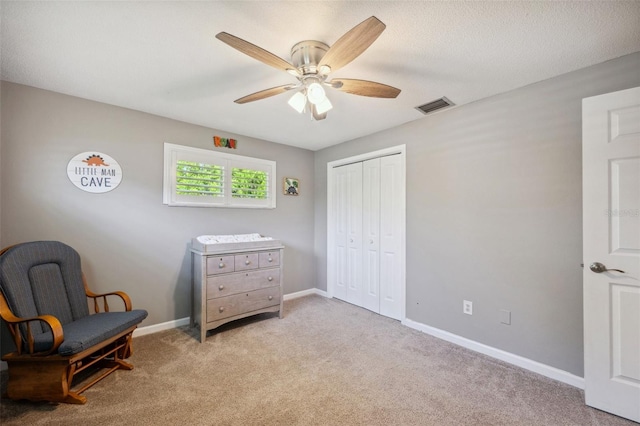 sitting room featuring carpet floors and ceiling fan