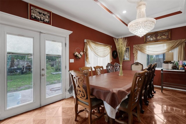 tiled dining room featuring a notable chandelier, ornamental molding, french doors, and a raised ceiling