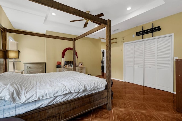 bedroom featuring a closet, ceiling fan, and a raised ceiling