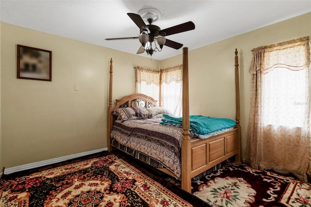 bedroom with multiple windows and ceiling fan