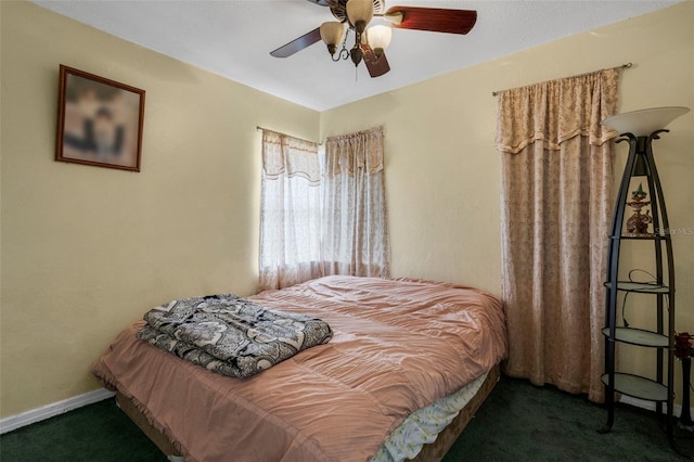 bedroom featuring ceiling fan and dark carpet