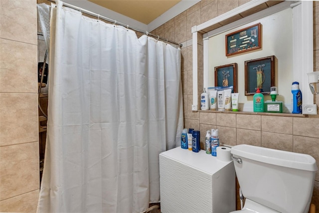 bathroom with tile walls and toilet