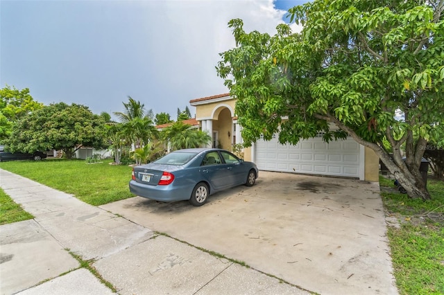 view of front of home with a garage and a front lawn