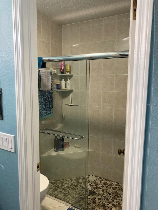 bathroom featuring a textured ceiling and toilet