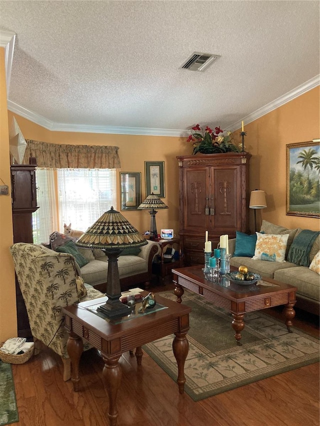 living room with a textured ceiling, ornamental molding, and wood-type flooring