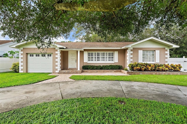 ranch-style home with a garage and a front yard