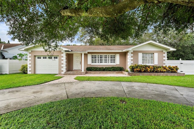 ranch-style home featuring a garage and a front yard