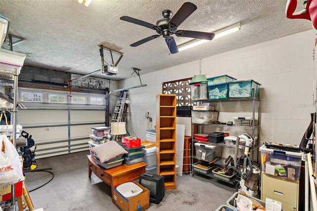 garage with a garage door opener and ceiling fan