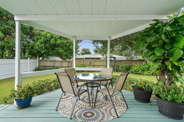 wooden deck featuring a lawn