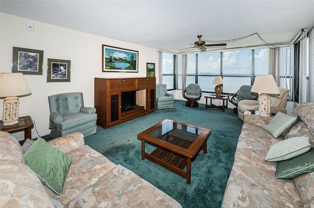 living room featuring a textured ceiling, ceiling fan, carpet, and floor to ceiling windows