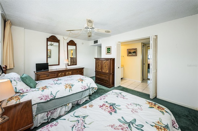 carpeted bedroom featuring a textured ceiling and ceiling fan