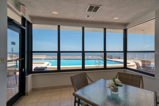 dining room featuring a textured ceiling and light tile patterned flooring