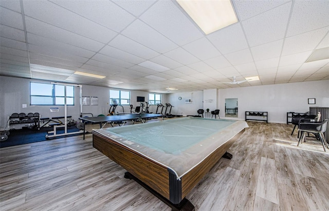 playroom with light wood-type flooring, a paneled ceiling, and billiards