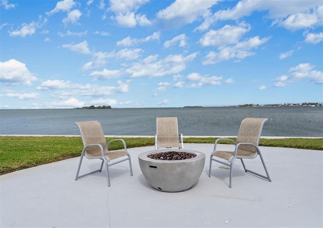 view of patio / terrace featuring an outdoor fire pit and a water view