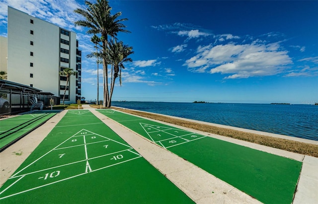 view of home's community featuring a water view and a beach view